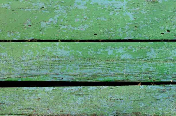Wooden boards. Tree structure. Old peeling paint. Wooden fence, door.