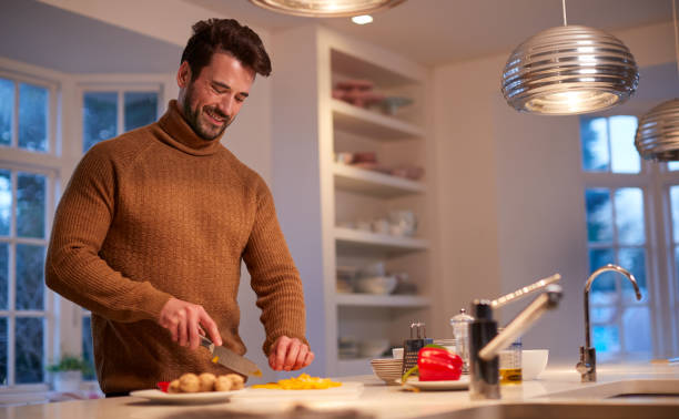istock Man In Kitchen At Home Preparing Ingredients For Meal 1256265935
