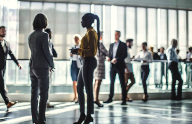 istock Businesspeople discussing in the hallway 1256267952