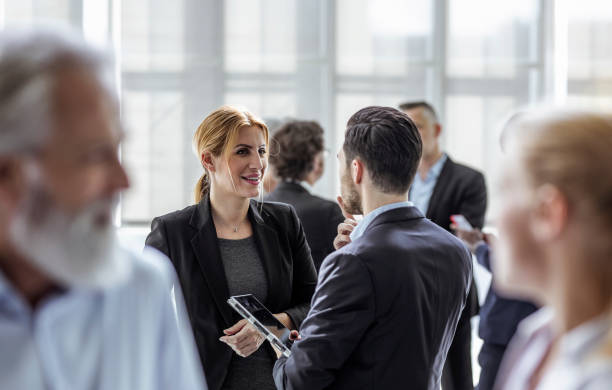 istock Businesspeople discussing in the hallway 1256267967