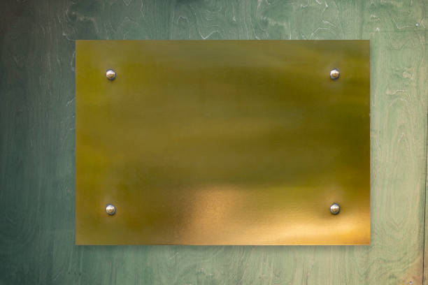 istock Empty gold metal plate on remote holders on the wall 1256268441