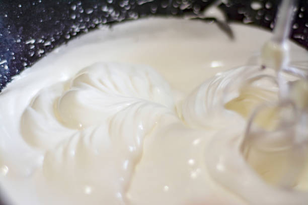 istock The mixer mixes thick, white cream 1256268465