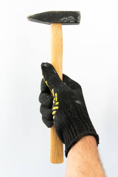 istock hammer in the hand of builder white background 1256270653