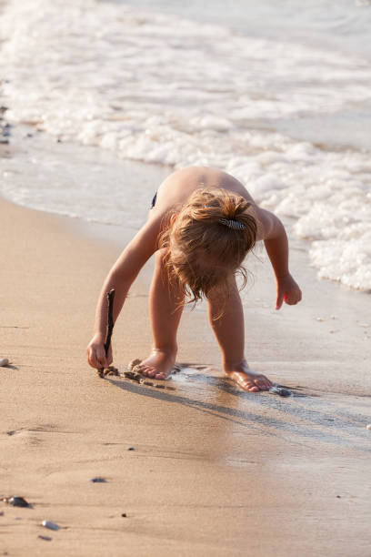istock little girl in the shallows 1256271021