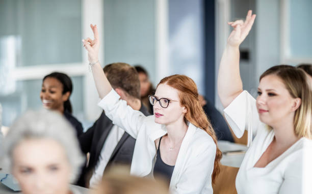 istock Businesspeople asking questions at a conference 1256272055