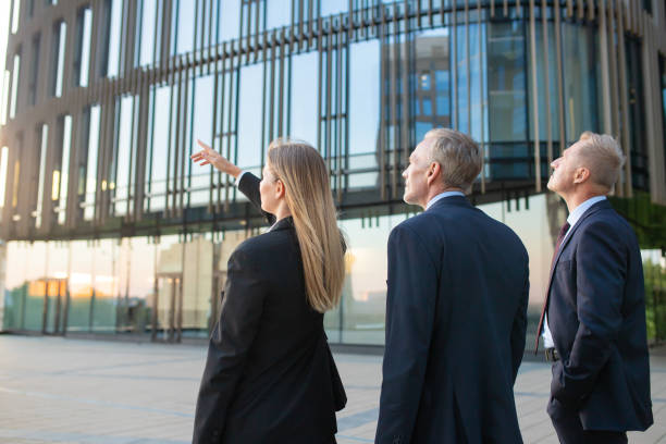 istock Agent and customers meeting outdoors 1256272086