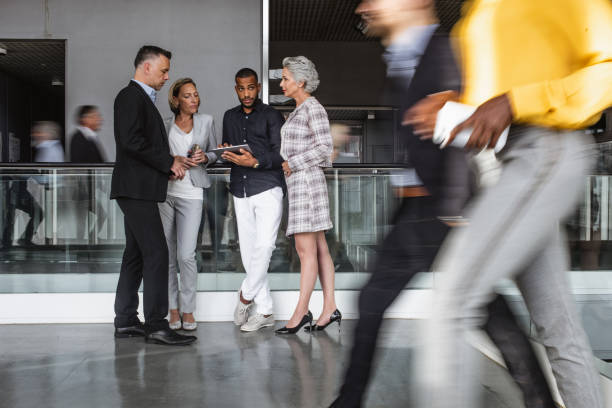 istock Business people at conference event, discussing in the lobby 1256273634