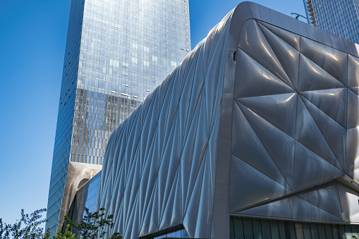 New York City, NY, USA - May 27, 2019: The Shed is a cultural center in Hudson Yards, Manhattan, New York City. Opened on April 5, 2019, the Shed commissions, produces, and presents a wide range of activities in performing arts, visual arts, and pop culture. Office skyscrapers on the back.