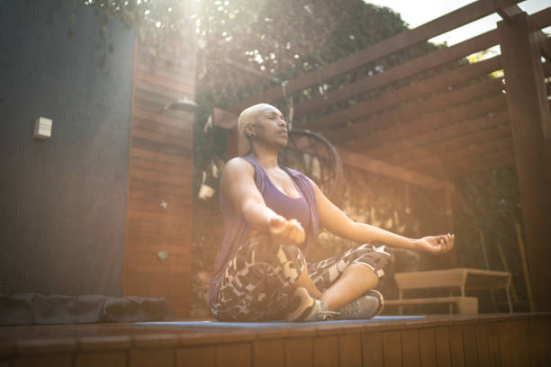 istock Woman meditating in the backyard 1256279116