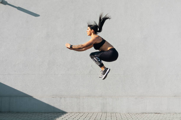 istock Muscular young woman jumping and running 1256280130
