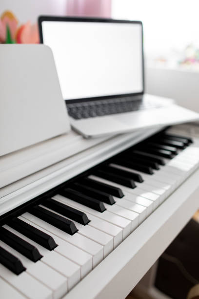 istock Coronavirus. Quarantine. Online piano music learning with a laptop, education and remote work. 1256280175