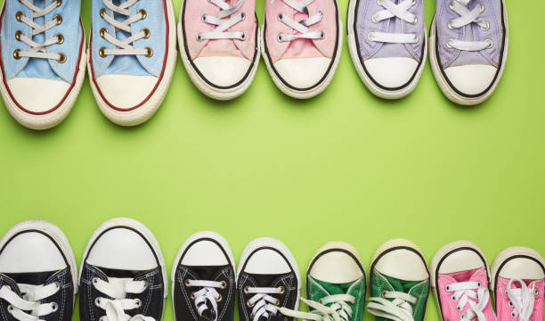 istock many multi-colored well-worn textile sneakers of different sizes on a green background 1256280331