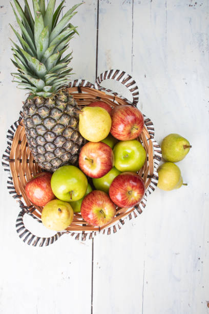 Pomegranates, pears and apples in a beautiful composition of seasonal healthy fruits. Red, yellow and green colors.