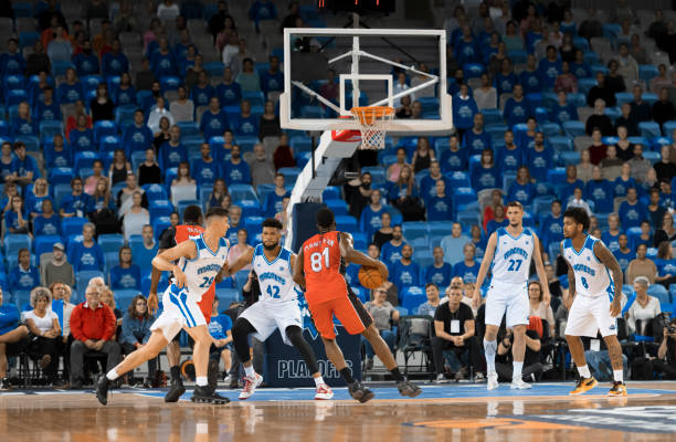 istock Basketball players chasing for ball 1256280796