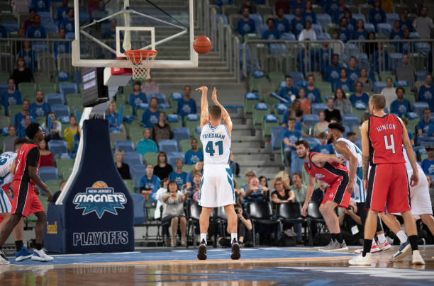 istock Basketball player shooting ball to basket 1256281353
