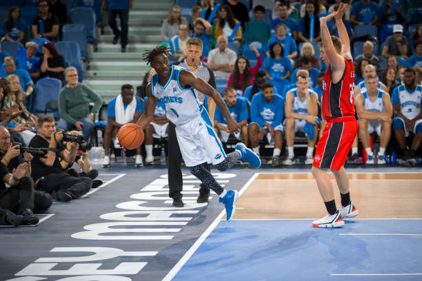 istock Basketball players tackling for ball 1256281667