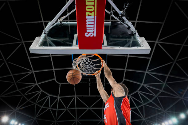 istock Basketball player hanging on hoop 1256281701