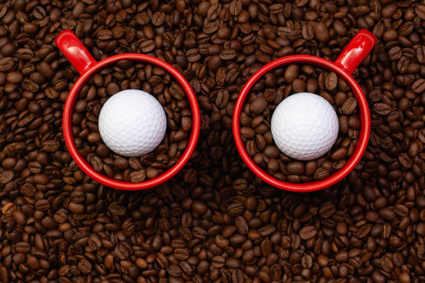 istock Two red cups full of coffee beans and one golf ball. 1256281720