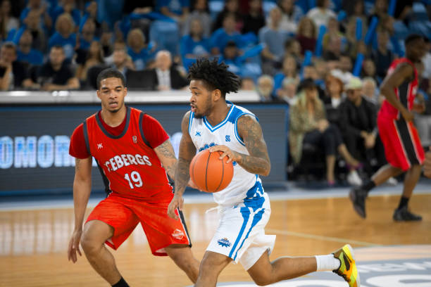 istock Basketball players chasing for ball 1256281745