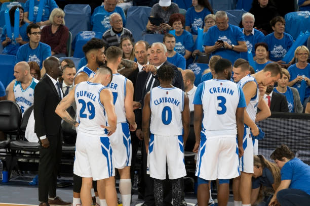 istock Coach giving instructions to basketball team 1256281779