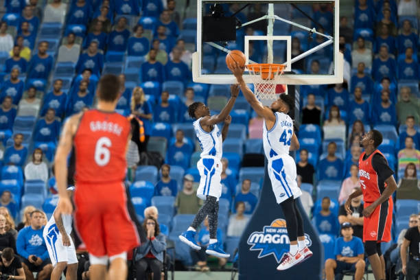 istock Basketball players aiming hoop 1256281826