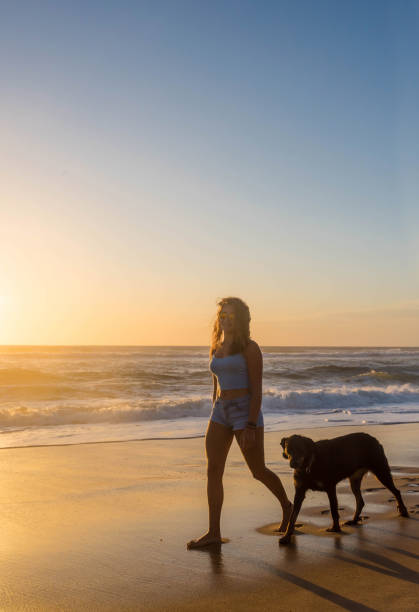 istock beautiful young woman strolling along the ocean 1256282888