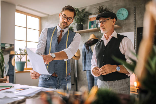 istock Young and senior cloth designers exchanging ideas 1256282943