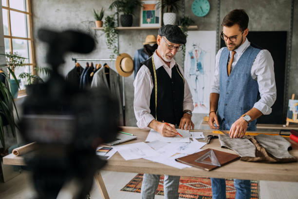 istock Senior and young professional cloth designers teaching online 1256282962