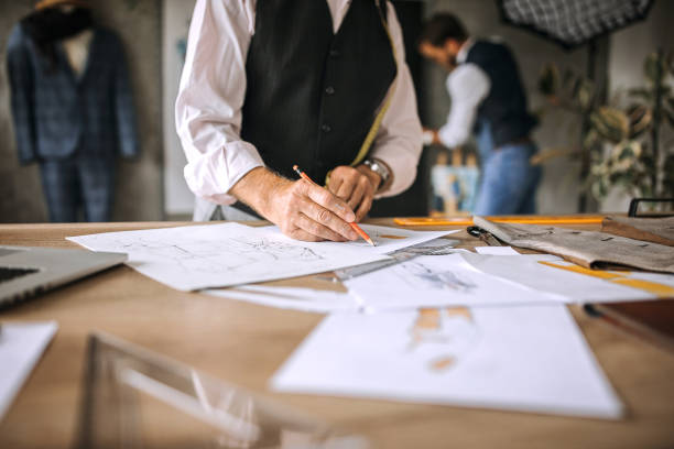 istock Senior tailor designer drawing cloth sketches 1256282989
