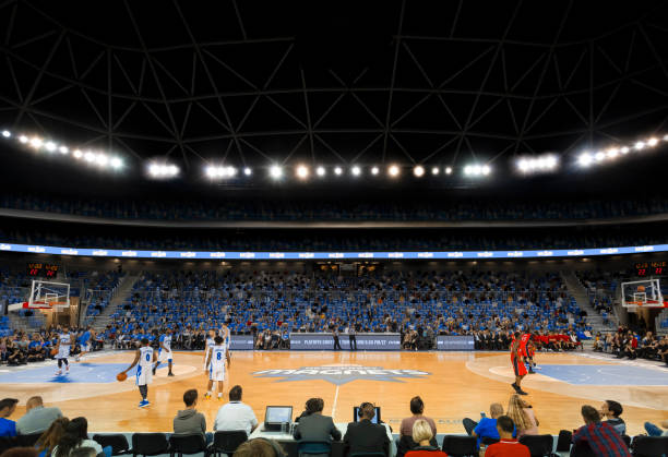istock Basketball players warming up on court 1256283377