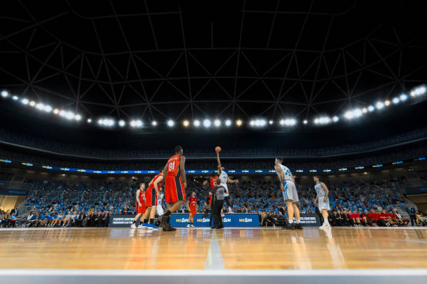 istock Basketball players chasing for ball 1256283392
