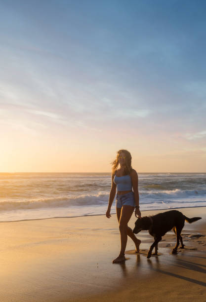 istock beautiful young woman strolling along the ocean 1256283430