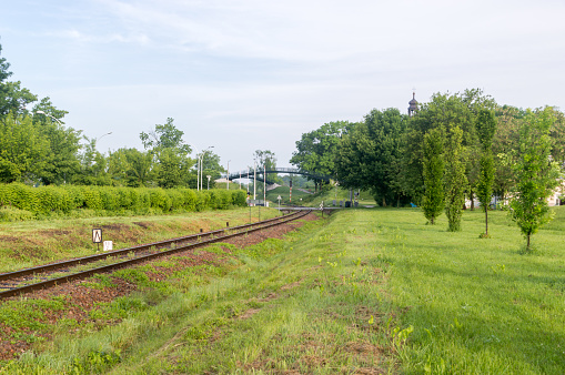 Railway tracks surrounded by nature.