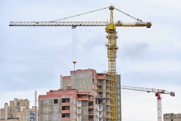 istock Construction of a high-rise residential building with a crane and workers. 1256287451
