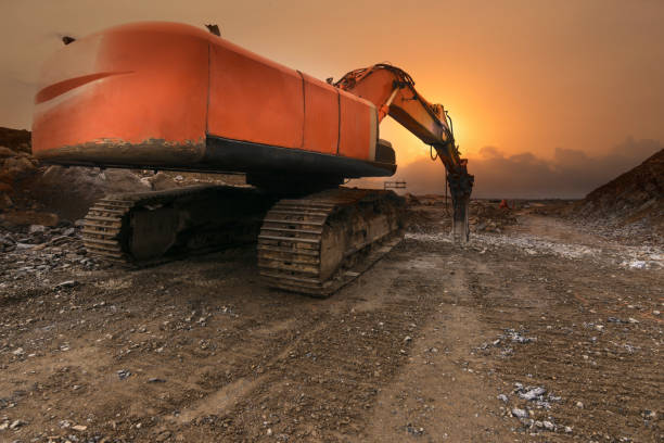 istock Hydraulic hammer drilling rock on road construction works 1256289892