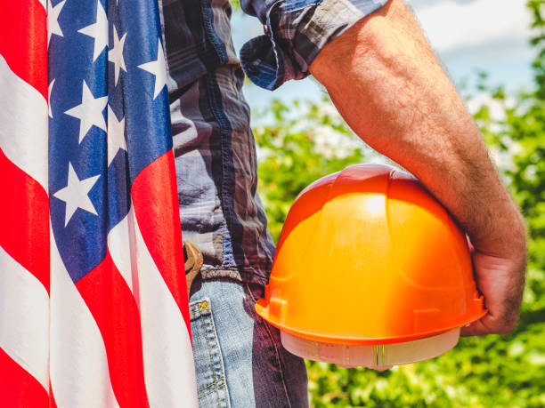 istock Handsome man with tools, holding an American Flag 1256290374