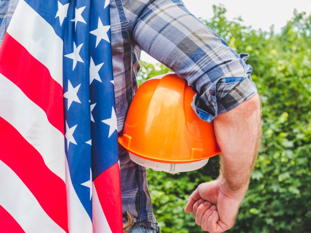 istock Handsome man with tools, holding an American Flag 1256291658