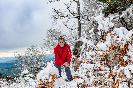 Mature man is walking and enjoying winter idyll, Primorska, Julian Alps, Slovenia, Europe