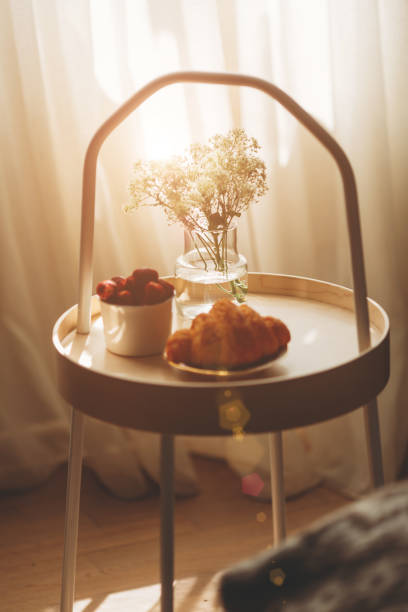 自宅の白いダークリネンのベッドのトレイで朝食。クロワッサンティーストロベリー - pillow bedroom bed rural scene ストックフォトと画像