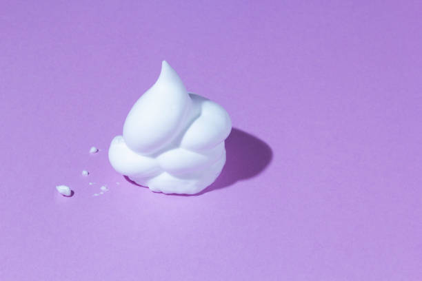 White foam on purple background. stock photo