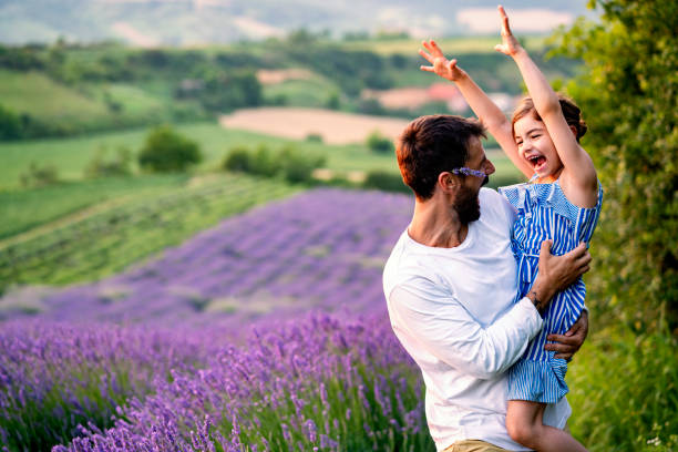 istock Father and daughter have fun in lavender field 1256297680