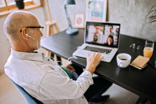 istock Senior man on a video conference call in his home office 1256298128