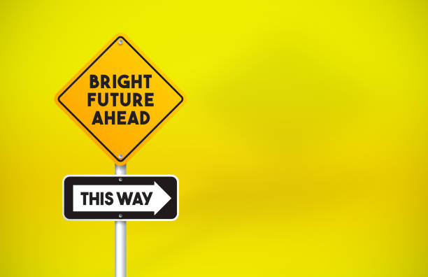 istock Bright Future Ahead Directional Road Sign On Yellow Background 1256298191