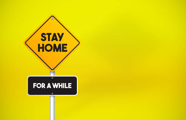 istock Stay Home Directional Road Sign On Yellow Background 1256298230
