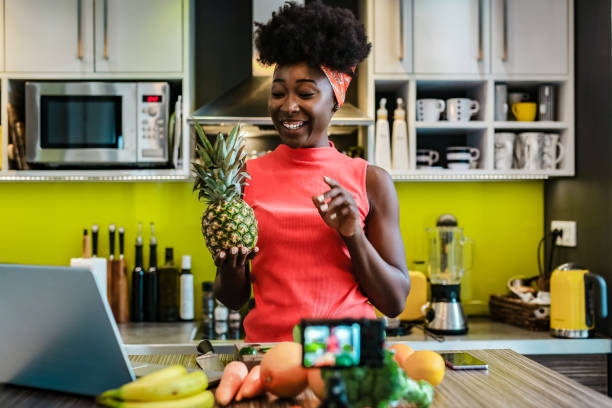 istock Female vlogger in the kitchen preparing healthy meal 1256299671