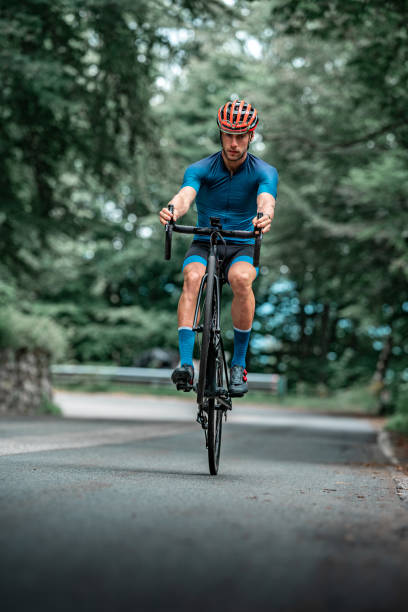 istock Bicycle racing cyclist on asphalt road wheelie 1256301225