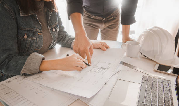 istock Architects are discussing and planning together at the desk with blueprints.construction & building concept. 1256301454