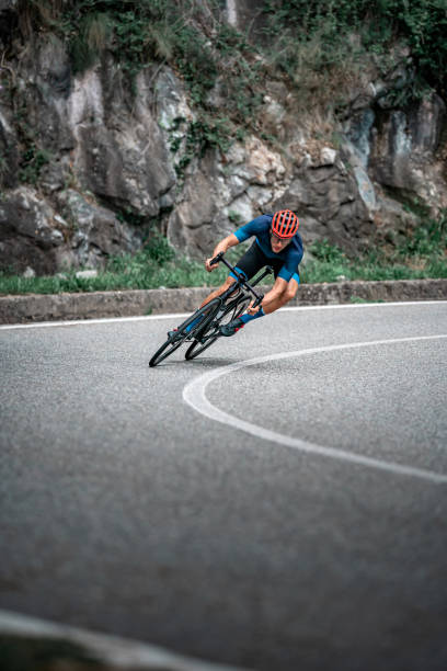 istock Bicycle racing cyclist on asphalt road curve 1256301530