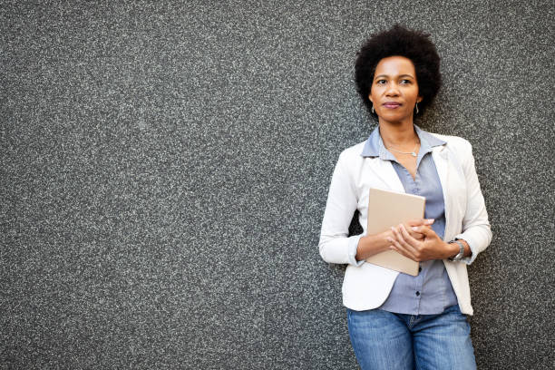 istock Urban happy business woman using tablet computer and working 1256302569