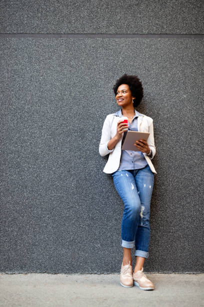 istock Urban happy business woman using tablet computer and working 1256302581